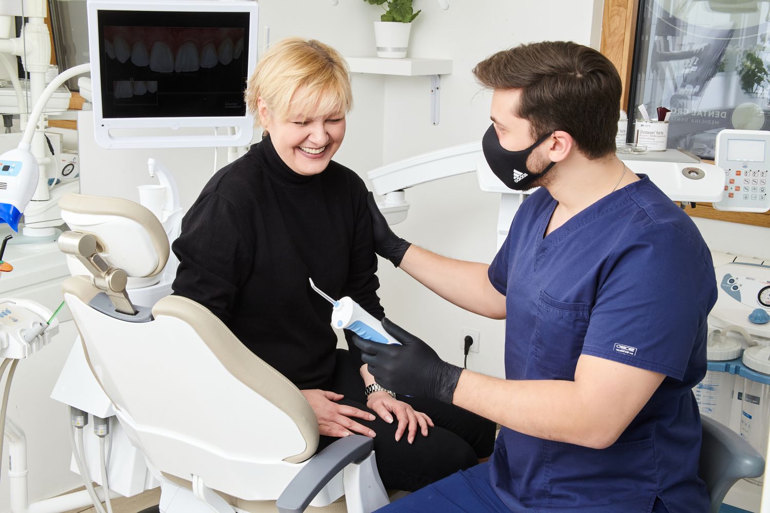 A dentist and patient talking through a treatment plan