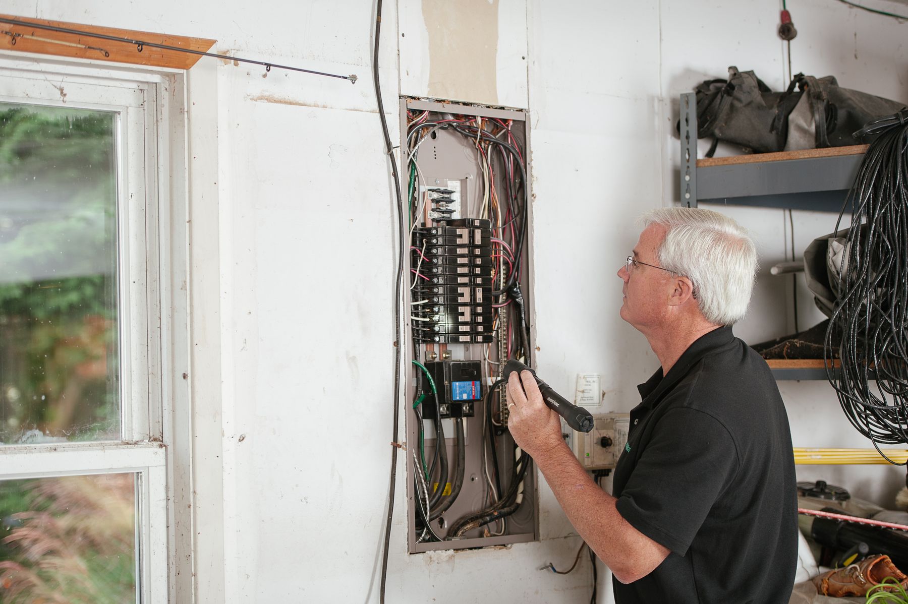 An electrician checking a household panel